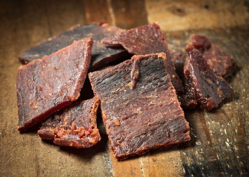 Pieces of original beef jerky on a wooden board