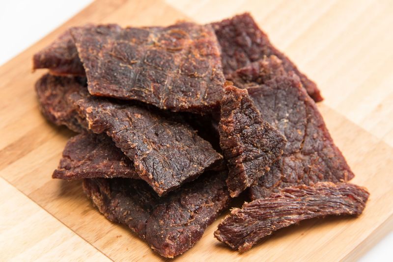 Teriyaki beef jerky pieces on a cutting board